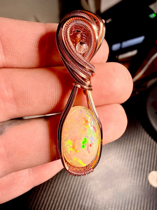 3EO) Ethiopian Welo Opal 6.60 Carats in polished copper with orange garnet & quartz accents.